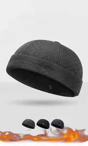 Detail view of winter quilted docker cap with sports style metal logo and diamond pattern
