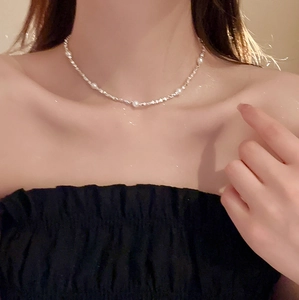 Detailaufnahme der Perlen-Choker-Halskette mit Silberperlen am Hals eines Models