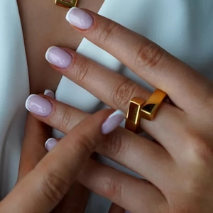 Minimalist S925 sterling silver geometric interlocking ring in gold finish worn by a woman