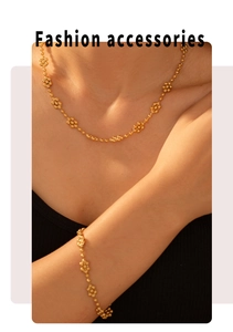 Fashion accessories detail showing golden beaded flower necklace and bracelet set on model
