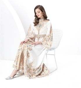 Detail of vintage paisley print dress featuring elegant stand collar and matching waist belt