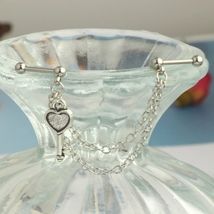 Detail of stainless steel double piercing ear chain with heart key pendant and screw ball back