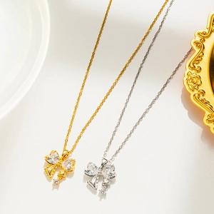 Close-up of gold and silver butterfly pendants with sparkling zircon stones in detail