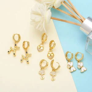 Detail shot of gold puppy balloon and mushroom earrings with zircon and colorful accents