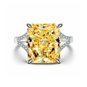 Luxury four-prong silver ring with large radiant cut yellow stone and paved side accents