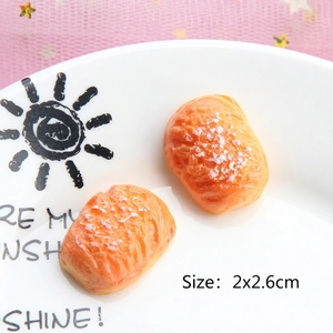 Detailed macro of realistic resin bread miniatures on a decorative plate for DIY crafts