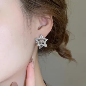 Elegant double-layered star earrings with sparkling cubic zirconia on a silver setting