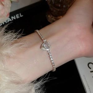 Close-up of heart-shaped tennis bracelet with sparkling diamonds in a luxury gift box