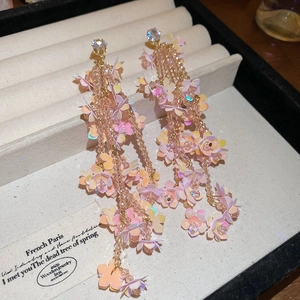 Detail of pink floral sequin tassel earrings with sparkling crystals and gold finish