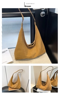 Detail of a brown frosted hobo bag showing minimalist crescent design and metal closure