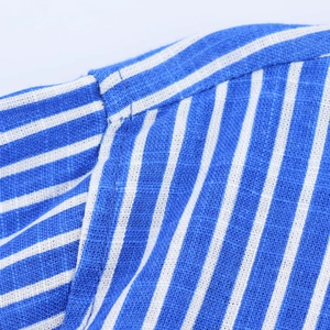 Macro shot of blue and white striped cotton-linen fabric with neat stitching detail