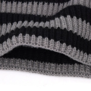 Detail of black and grey striped ribbed knit fabric showing the thick elastic texture