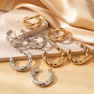 Polished titanium steel C-shaped twisted and layered hoop earrings in gold and silver finish