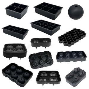 Black silicone ice cube molds set with square, sphere, and honeycomb shapes on white base