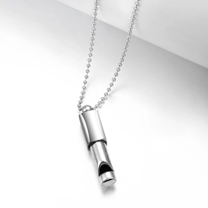 Detail of silver titanium steel whistle pendant with 120 DB engraving and bead chain