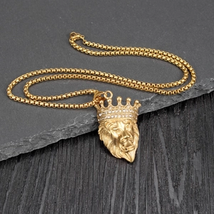 Macro shot of gold hip-hop lion head pendant with crystal crown on box chain necklace