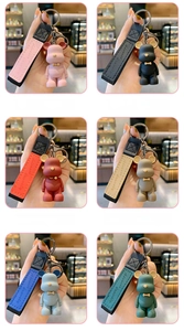 Grid view showing variety of colorful bow-tie bear keychains with matching leather straps