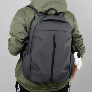 Minimalist grey water-resistant oxford backpack with vertical zipper and white plush toy