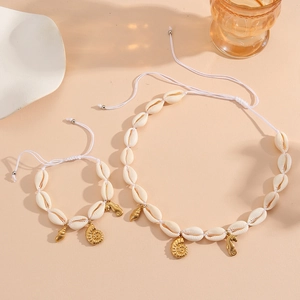 Detail of seashell jewelry set featuring golden seahorse and conch charms with woven cord