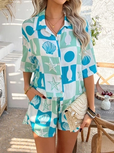Detail of bohemian two-piece set featuring blue shell and starfish geometric prints