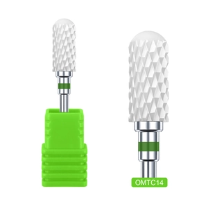 Macro detail of white ceramic nail drill bit with green ring and stainless steel shank
