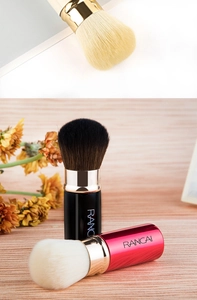 Detailed view of portable retractable makeup brushes in gold black and red colors