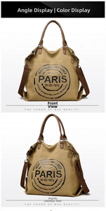 Close-up of canvas tote bag with brown leather handles and vintage Paris logo detail