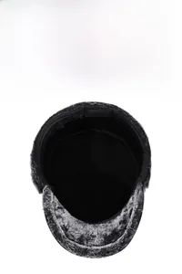 Detail view of winter flat cap showing thick faux fur lining and warm ear protection