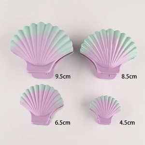 Set of shell-shaped hair clips in gradient colors showing four different sizes
