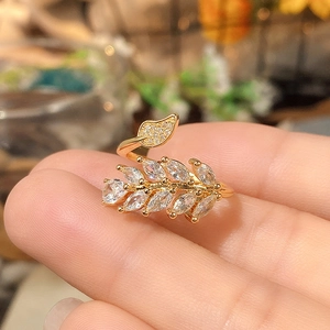 Detailed view of adjustable leaf ring with marquise-cut zircons and gold plating