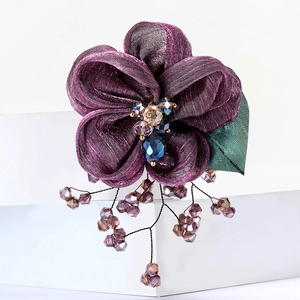 Elegant purple lace flower brooch with silk petals and crystal beads on a gold base