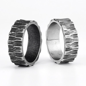 Close-up of wide bark texture rings in dark grey and bright silver stainless steel