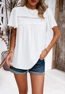 Detail view of white short sleeve top with lace stitching and textured swiss dots