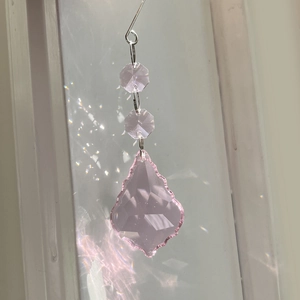 Macro shot of 50mm pink faceted crystal maple leaf pendant with beautiful light refraction