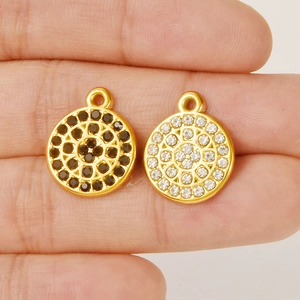 Close-up of 304 stainless steel round pendants with black and white rhinestones