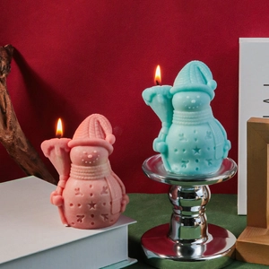 Detailed view of snowman candles with knit textures and star reliefs on festive background