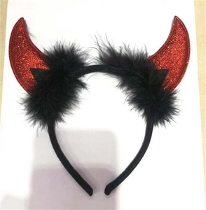 Detail of red sequined devil horns headband with black feather trim for parties