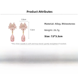 Detail view of pink teardrop crystal earrings with size measurements of 7.3 by 3.3 cm