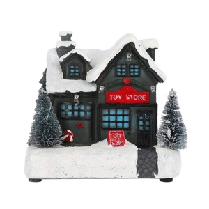 Close-up of a Christmas Toy Store miniature with snow texture and festive LED lights