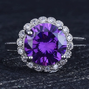 Macro shot of 5 carat purple gemstone ring with halo diamonds and vintage milgrain edge