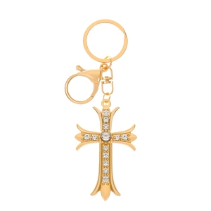Detailed view of a gold-tone cross keychain featuring sparkling clear rhinestones on white