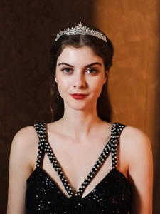 Detailed view of silver bridal crown with marquise rhinestones worn by a model