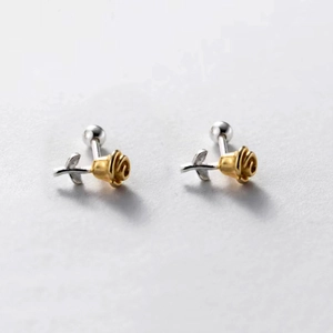 Macro shot of two-tone 3D rose studs with matte gold petals and silver leaf backing