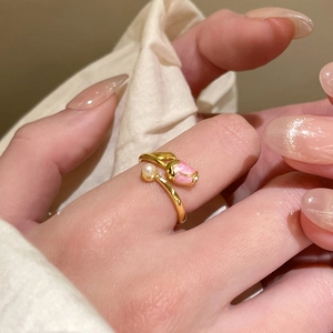 Close-up of 18k gold plated tulip open ring with pink enamel flower and white pearl detail