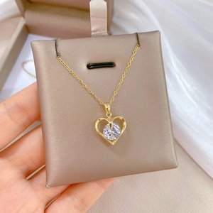 Elegant gold titanium necklace featuring a hollow heart pendant and sparkling zircon stone