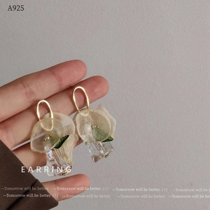 Detail of floral earrings with soft yellow tulle petals and crystal drops featuring A925 stamp