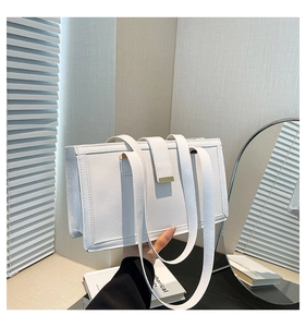 Detail of white rectangular shoulder bag with wrinkled leather texture and metal buckle