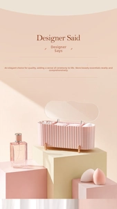 Detail view of pink fluted makeup storage box with clear lid and gold legs for cotton pads