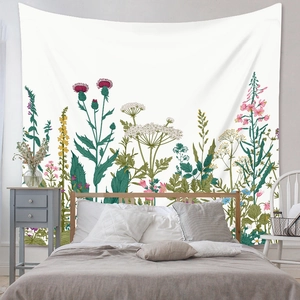 Bohemian tapestry wall hanging featuring botanical wildflower print over a bedroom headboard