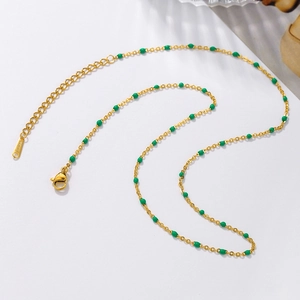 Detail of gold stainless steel necklace with green beads and adjustable lobster clasp